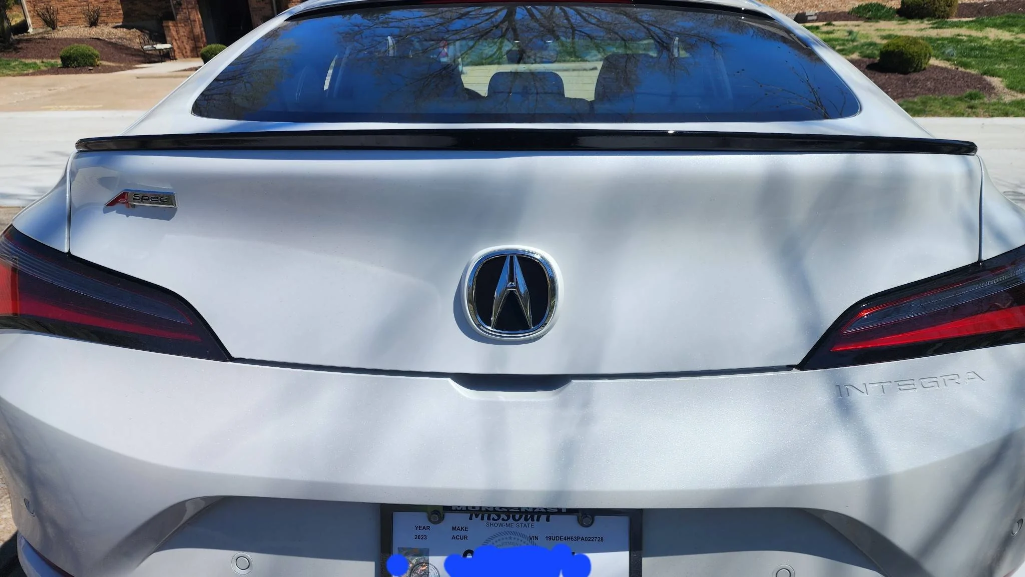 Acura Integra Rear black emblem install with white background. messages_0