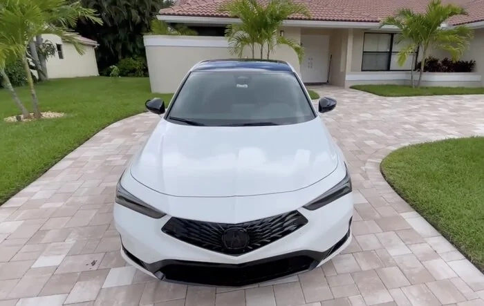 White 2023 Integra with vinyl wrapped gloss black roof, mirrors, and Acura front and back emblem
